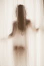Artistic Silhouette of a Woman Behind Curtain