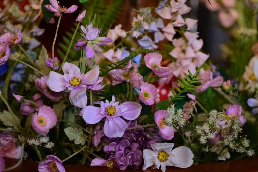 Vibrant close-up of a diverse floral arrangement featuring pink and purple blooms.