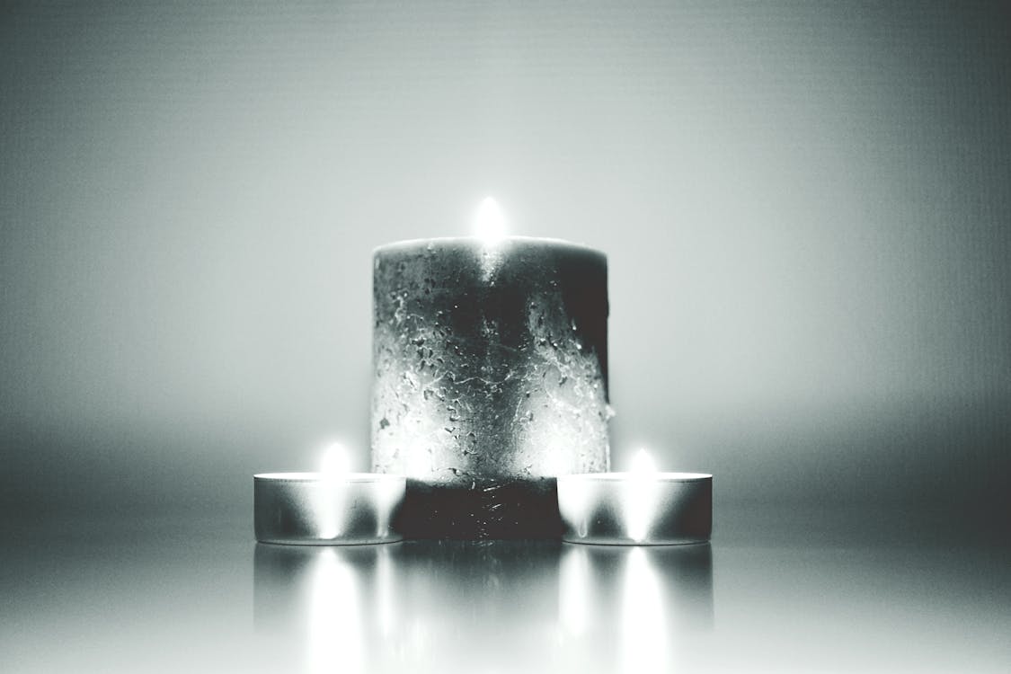 Photography of Three Lighted Candles