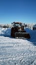 Tractor Clearing Snow in Winter Landscape