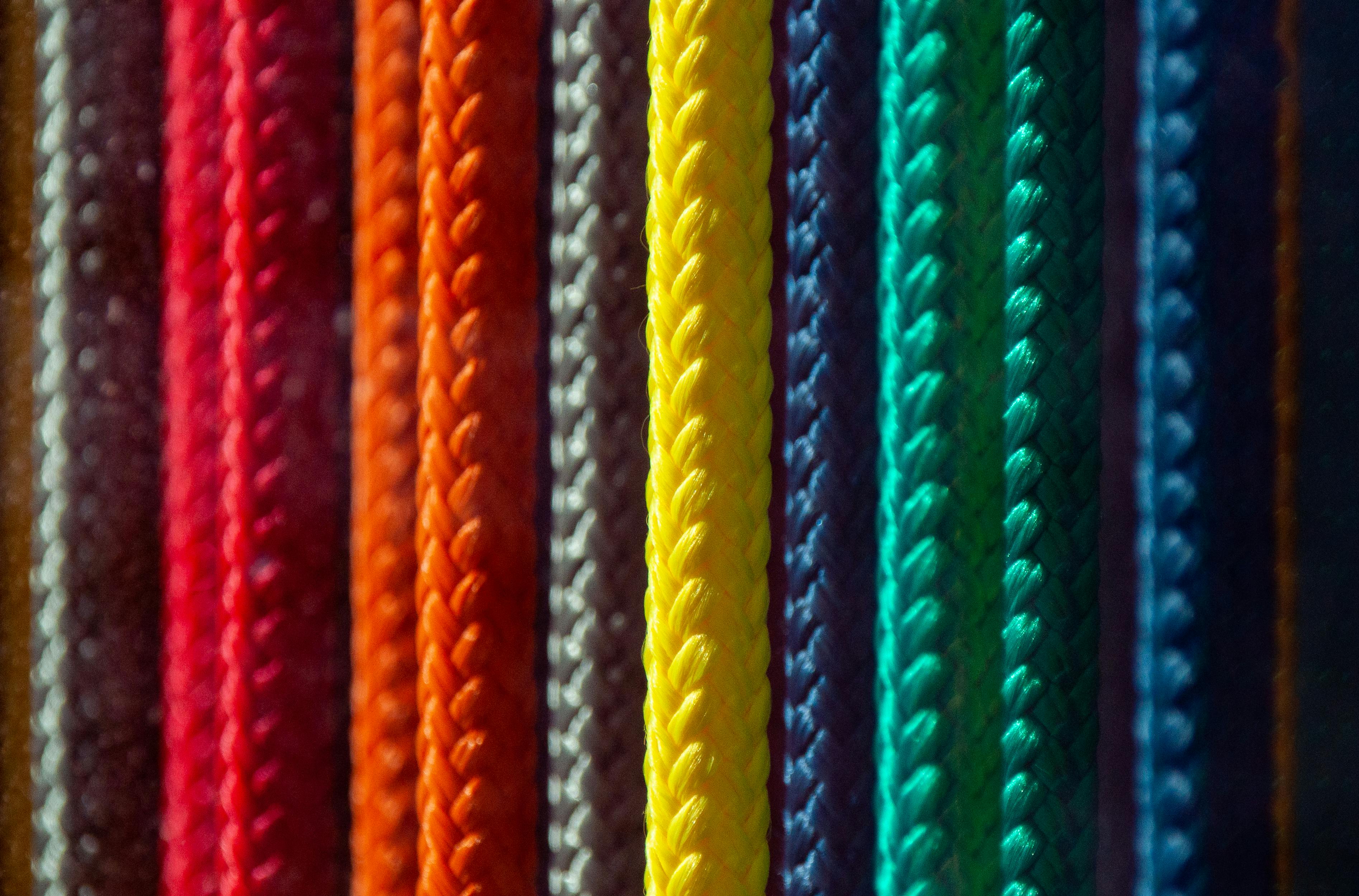 Zadarmo Žiarivé pletené laná v rôznych farbách usporiadané vertikálne, zobrazujúce dúhové spektrum. Fotka z fotobanky