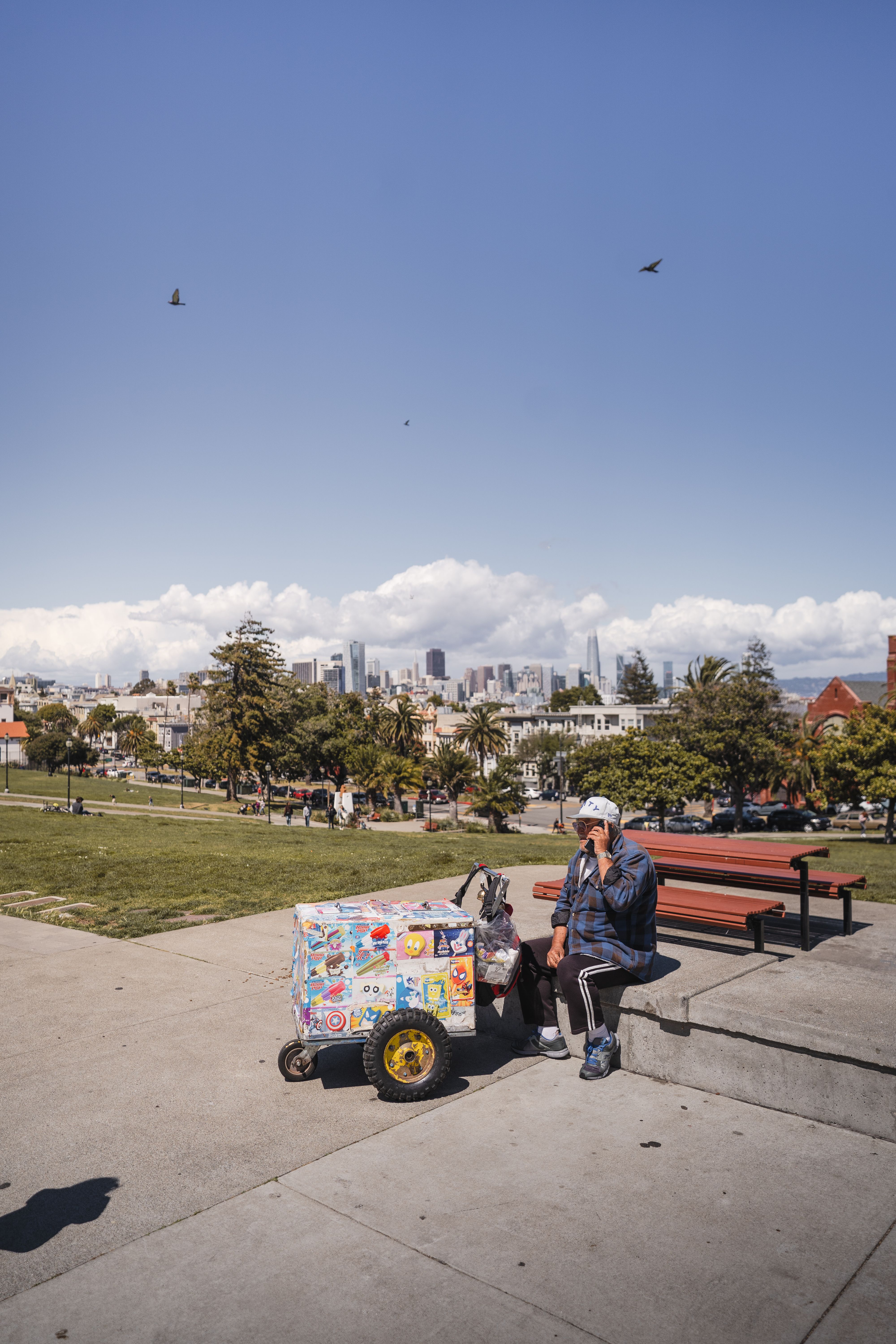 Mission Dolores Park lawn with San Francisco skyline in the background.