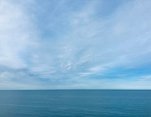 Free Vast blue sky meeting tranquil ocean. Perfect for relaxation themes. Stock Photo