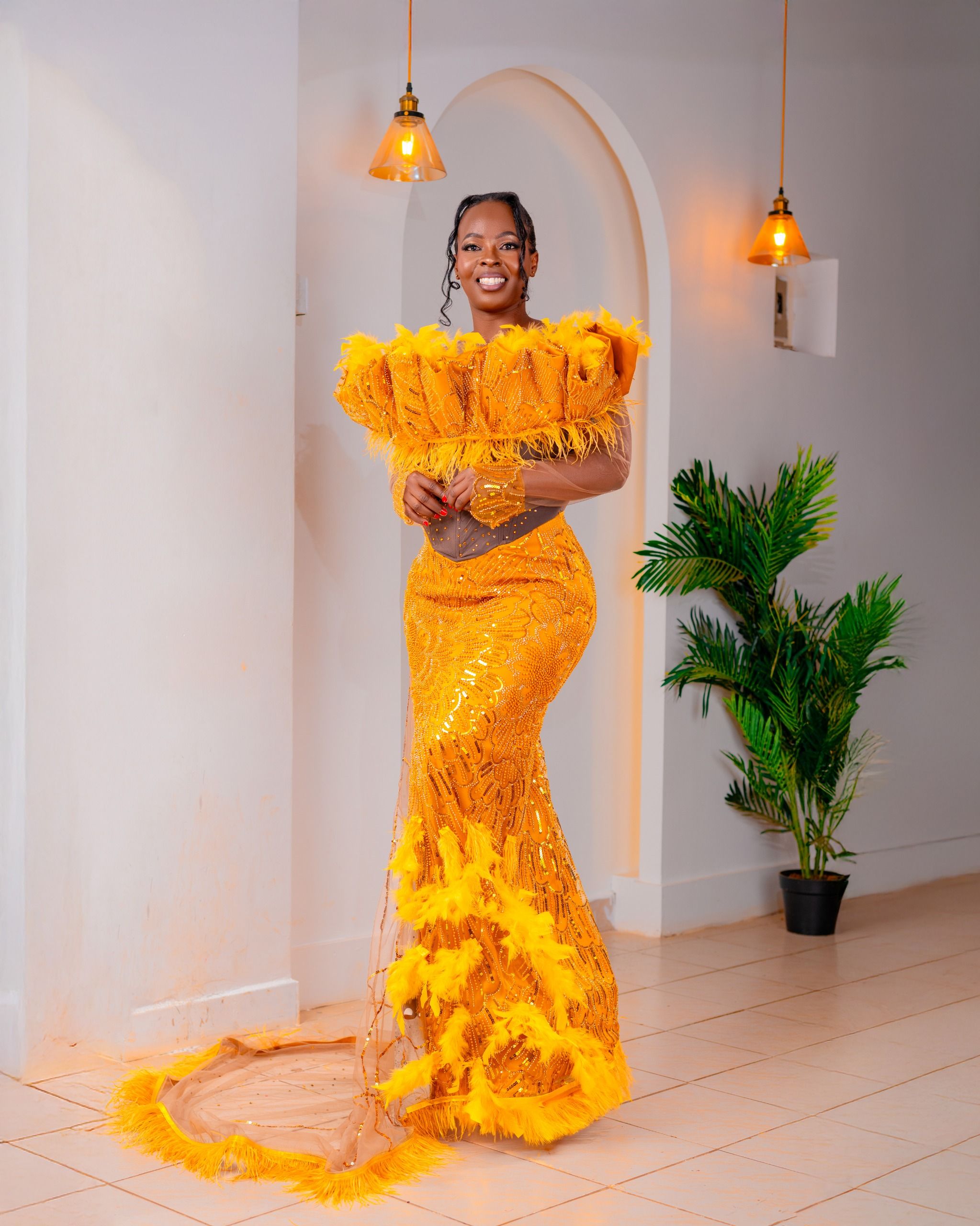 Elegant Woman in Vibrant Yellow Dress Indoors · Free Stock Photo