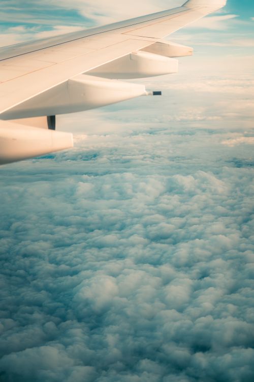 Free Serene aerial shot capturing the clouds from an airplane flying over Warsaw, Poland. Stock Photo