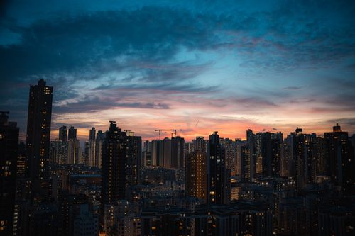 Free Breathtaking view of Hong Kong skyscrapers silhouetted against a vibrant twilight sky. Stock Photo