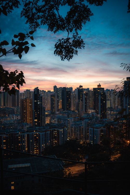 Free Captivating view of Hong Kong's skyline with vibrant city lights during twilight from an elevated position. Stock Photo