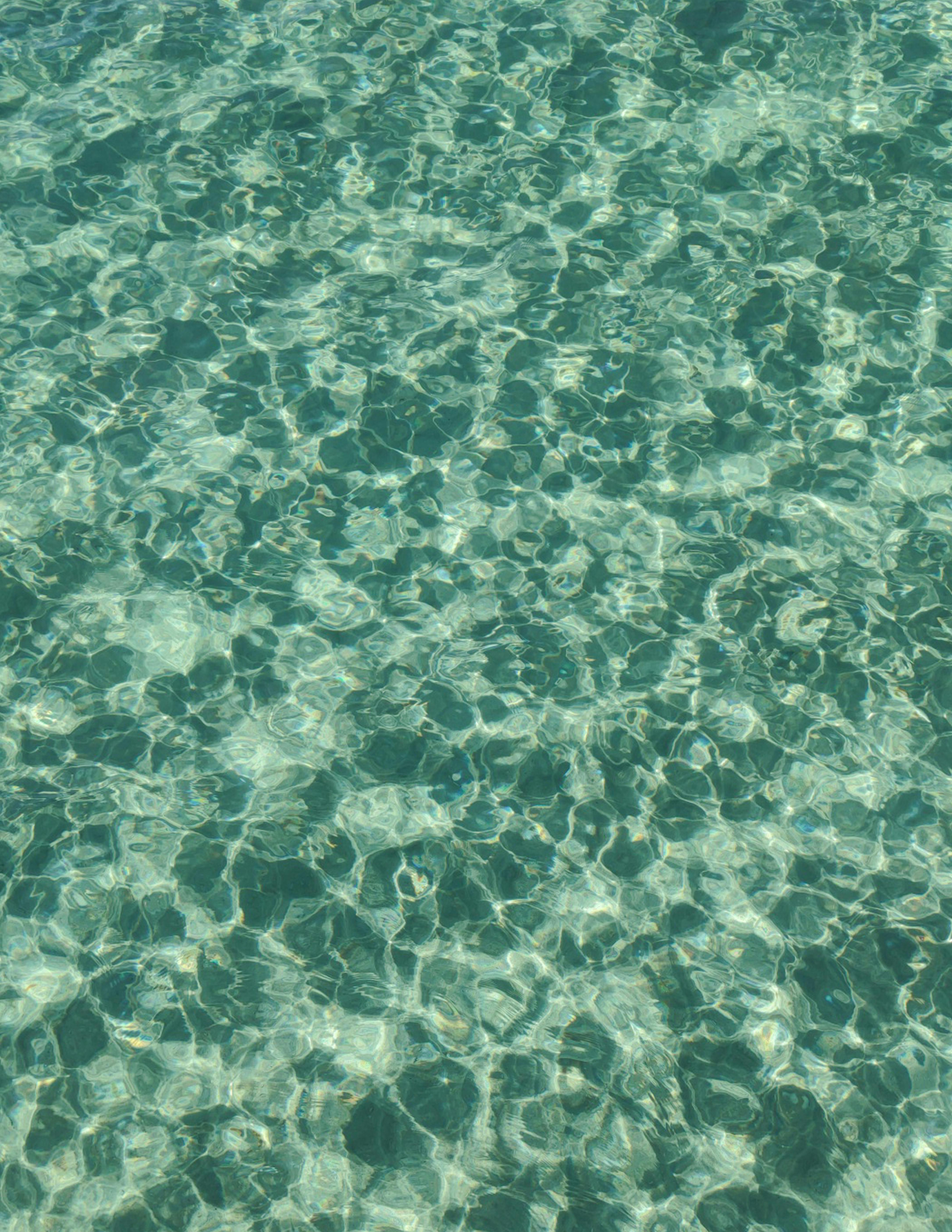 A vibrant image of clear, rippled water capturing sunlight reflections.