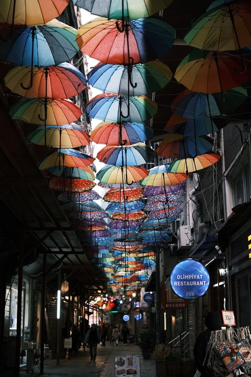 Free Colorful umbrellas create a vibrant canopy over a street in Istanbul, Türkiye. Stock Photo
