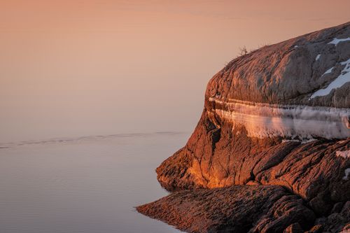 Free Tranquil winter sunrise reflecting on icy cliff at Cove Island Park, Stamford, Connecticut. Stock Photo