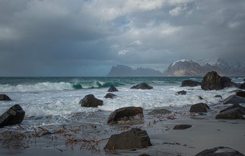 Free Dramatic seascape with waves crashing on rocks at Lofoten, Norway. Stock Photo