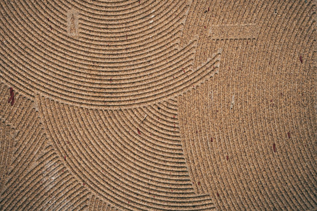 close up of a coir mat showcasing intricate circular patterns and text