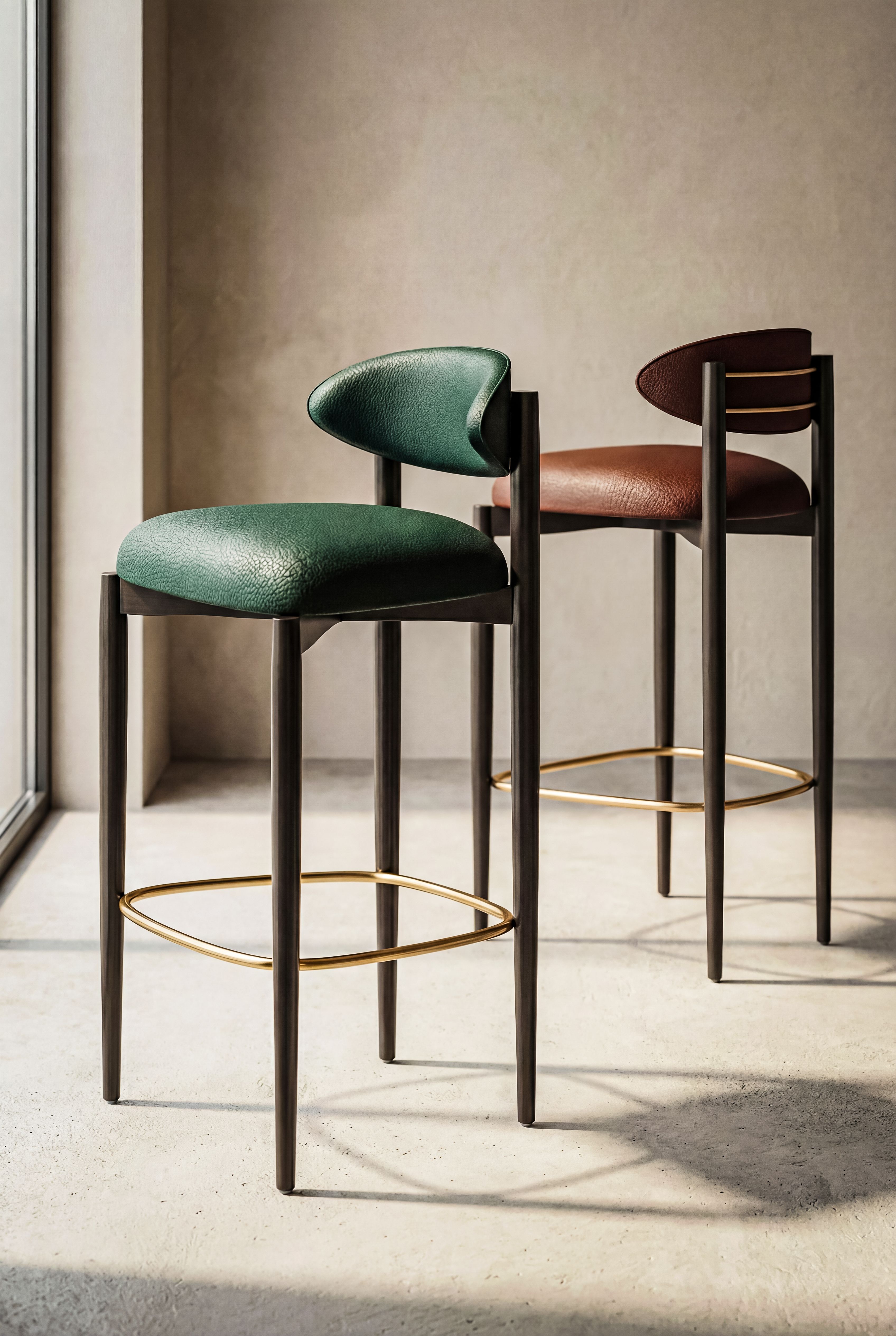 Stylish green and brown bar stools in a sunlit minimalist interior.
