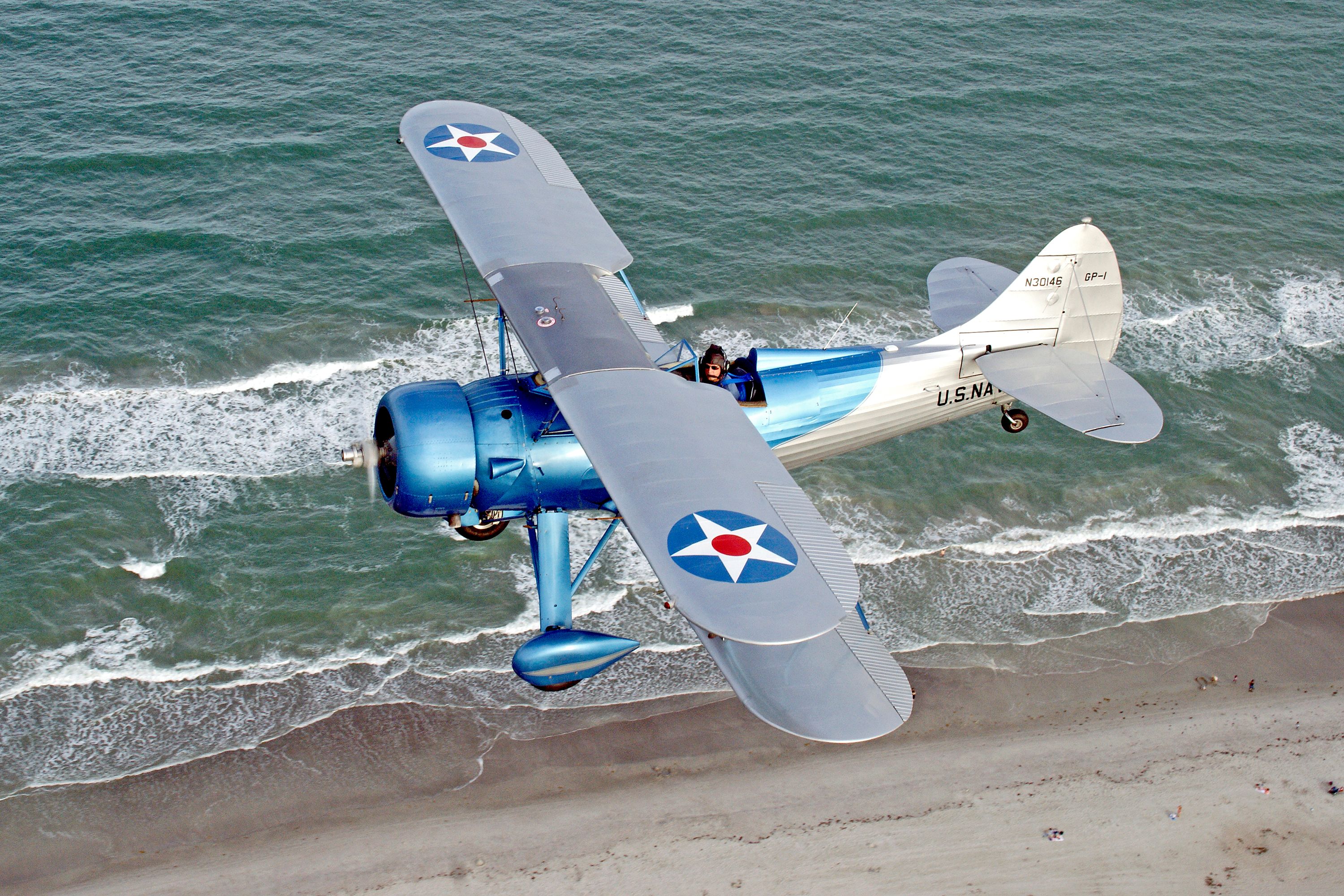 Historic Biplane Flying Over Florida's Ocean Shore · Free Stock Photo