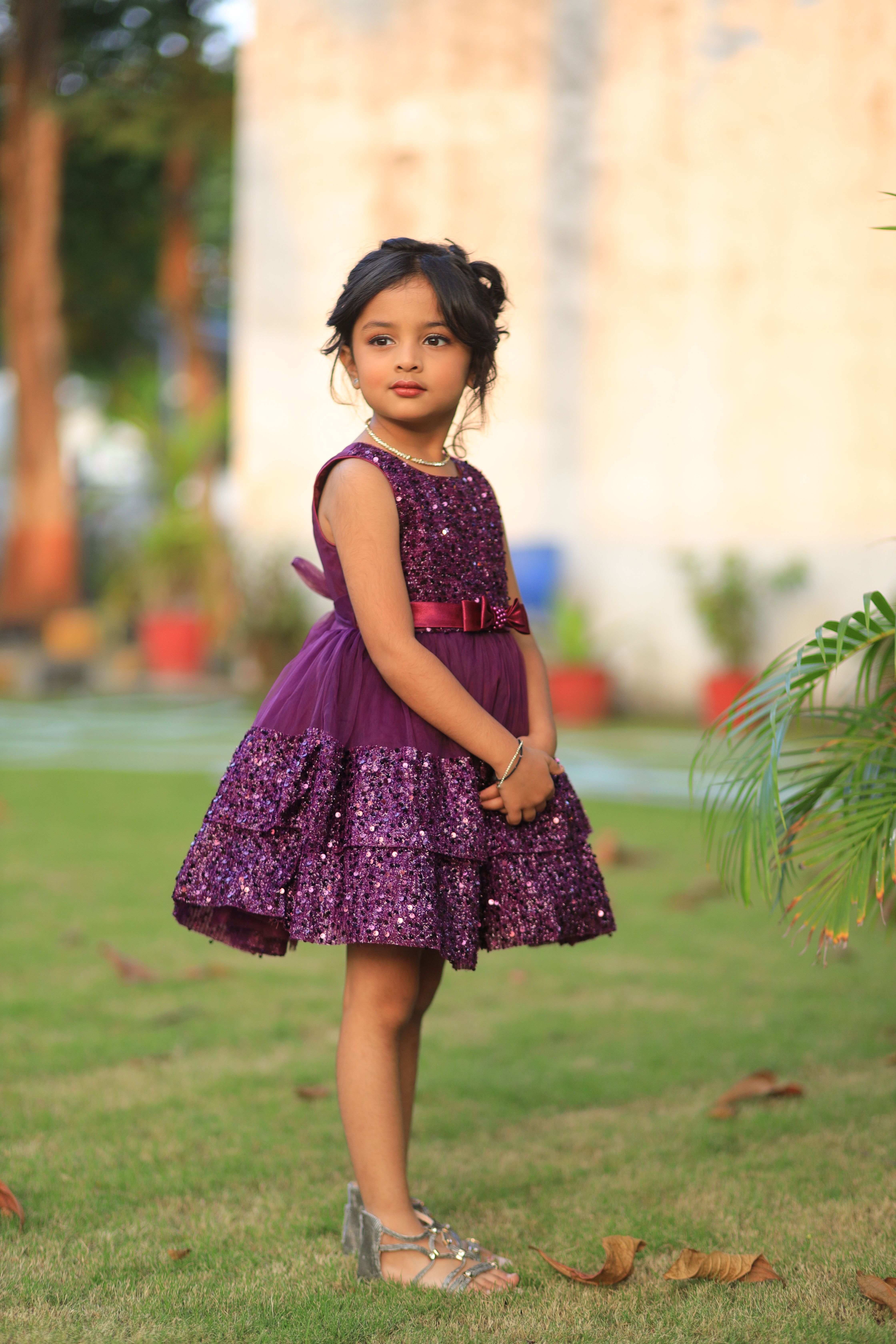 Charming Young Girl in a Purple Dress Outdoors · Free Stock Photo