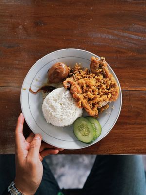 Fried chicken with rice on a white plate, photo by Scenehaus Production on Pexels