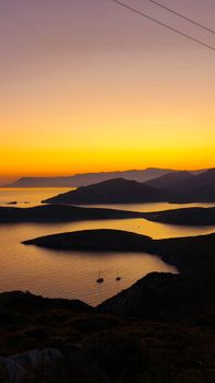 Stunning view of Aegean islands during sunset with vibrant sky hues.