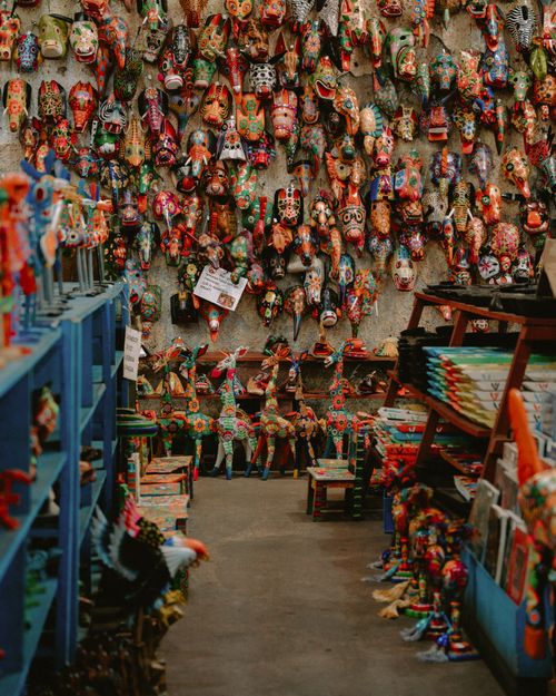 Free Vibrant display of handmade Guatemalan ceramic masks in a shop. Perfect for cultural art themes. Stock Photo