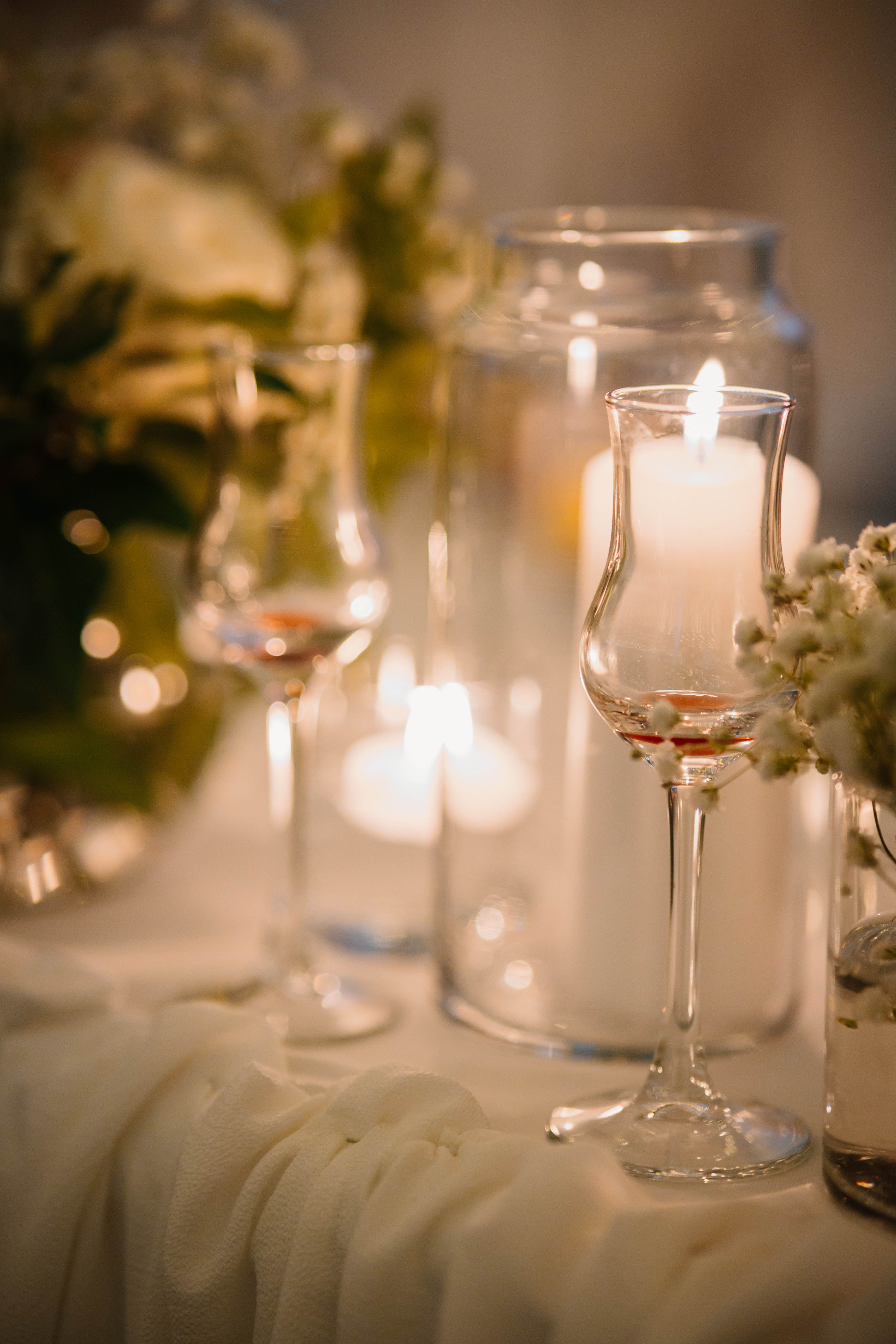 Private dinner party with candlelit table and floral arrangements