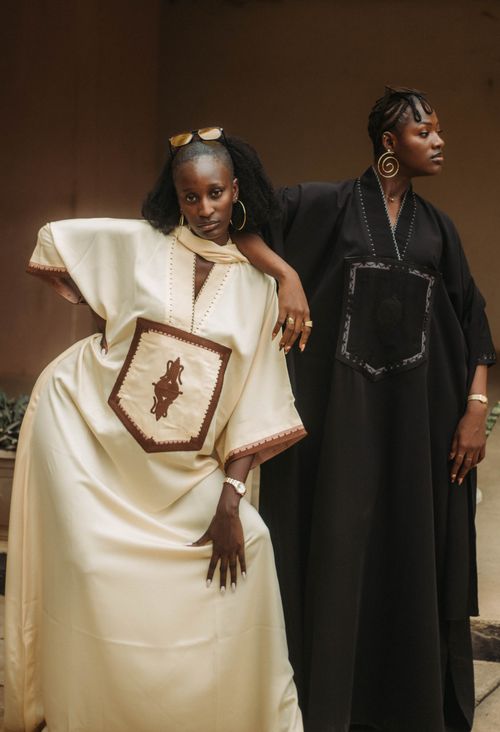 Free Two stylish models in traditional African clothing showcasing elegance indoors. Stock Photo