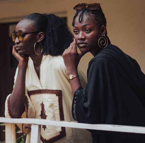 Free Two stylish women pose with elegance and confidence, showcasing cultural fashion. Stock Photo