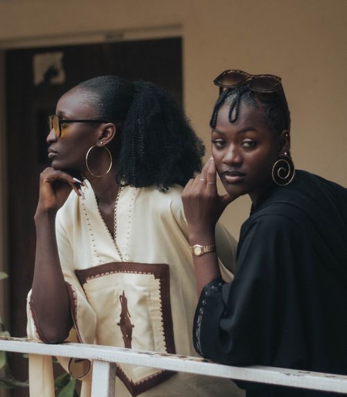 Free Two fashionable young women wearing sunglasses and jewelry, enjoying a moment outdoors. Stock Photo