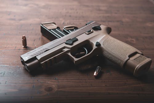 Black and Silver Semi Automatic Pistol on Brown Wooden Table