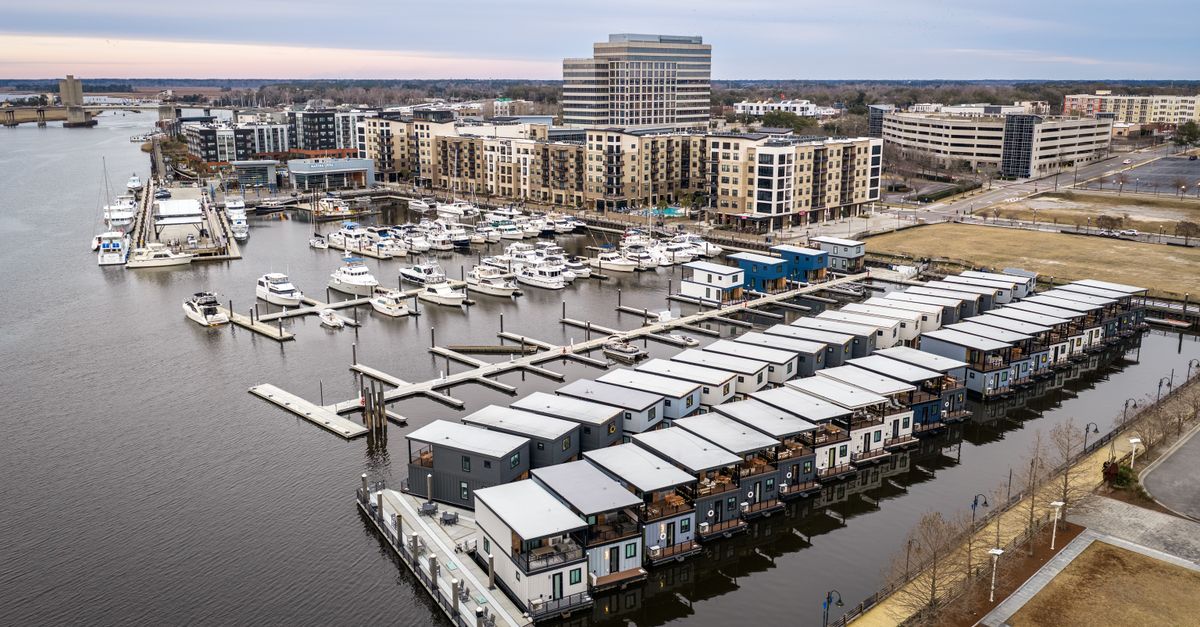 Aerial view of the Wilmington Marina showcasing houseboats and waterfront buildings, ideal for travel and lifestyle themes.