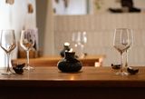 Candlelit table set with wine glasses — photo by Mimi on Pexels