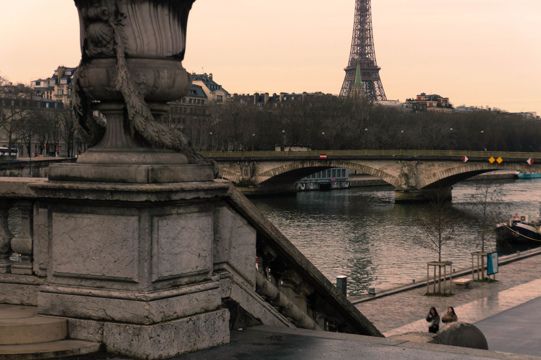 Elegant view of the Eiffel Tower with the Seine River in Paris. Captures the essence of the city's charm and architecture.
