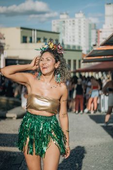 Smiling woman in vibrant costume enjoying a sunny outdoor festival.