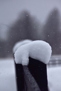 Capture of a snow-covered fence in a serene winter scene, emphasizing texture.
