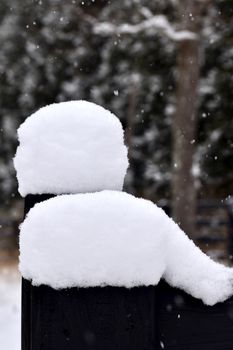 Pristine snow on a fence captures the essence of a peaceful winter day.