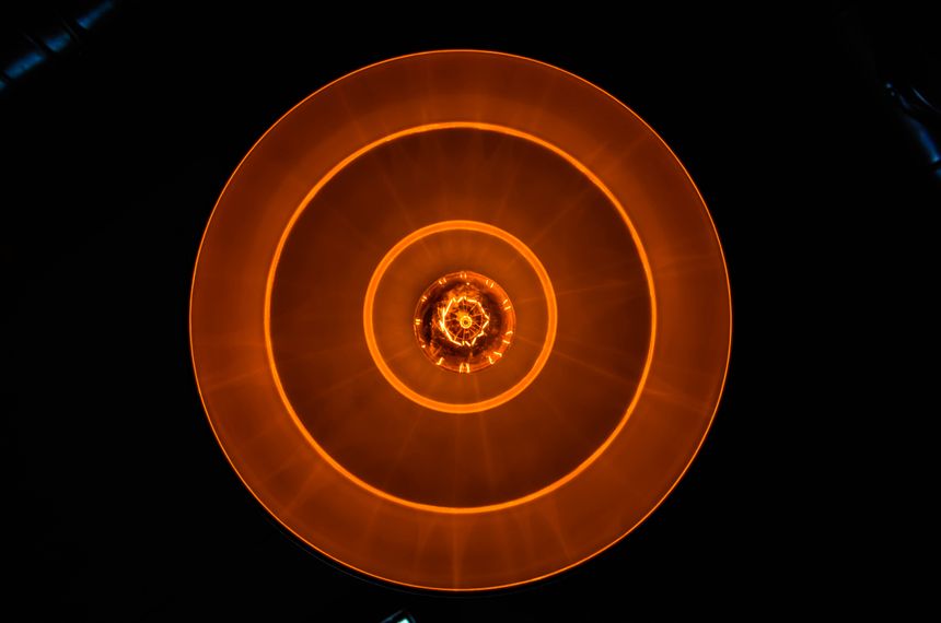 Concentric amber signal rings in the dark — photo by asim alnamat on Pexels