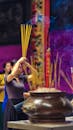 Woman Offering Incense in Vietnamese Temple