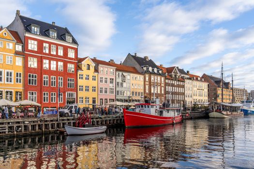 Vibrant Nyhavn waterfront with colorful historic buildings and boats in Copenhagen, Denmark.
