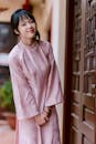 Young Woman in Traditional Pink Dress Indoors