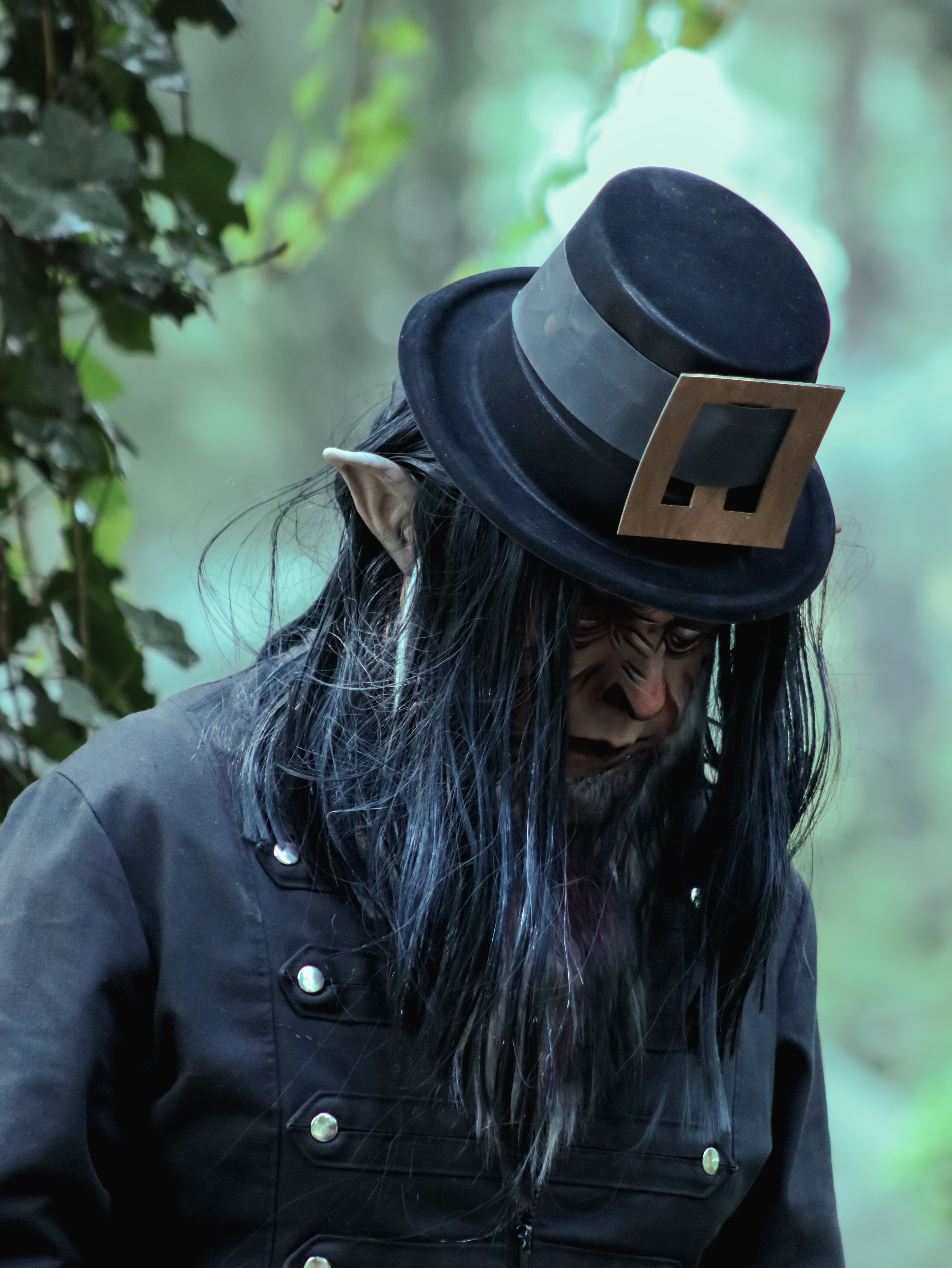 A haunting figure resembling an elf in mysterious forest attire, evoking a sense of folklore and mystique.