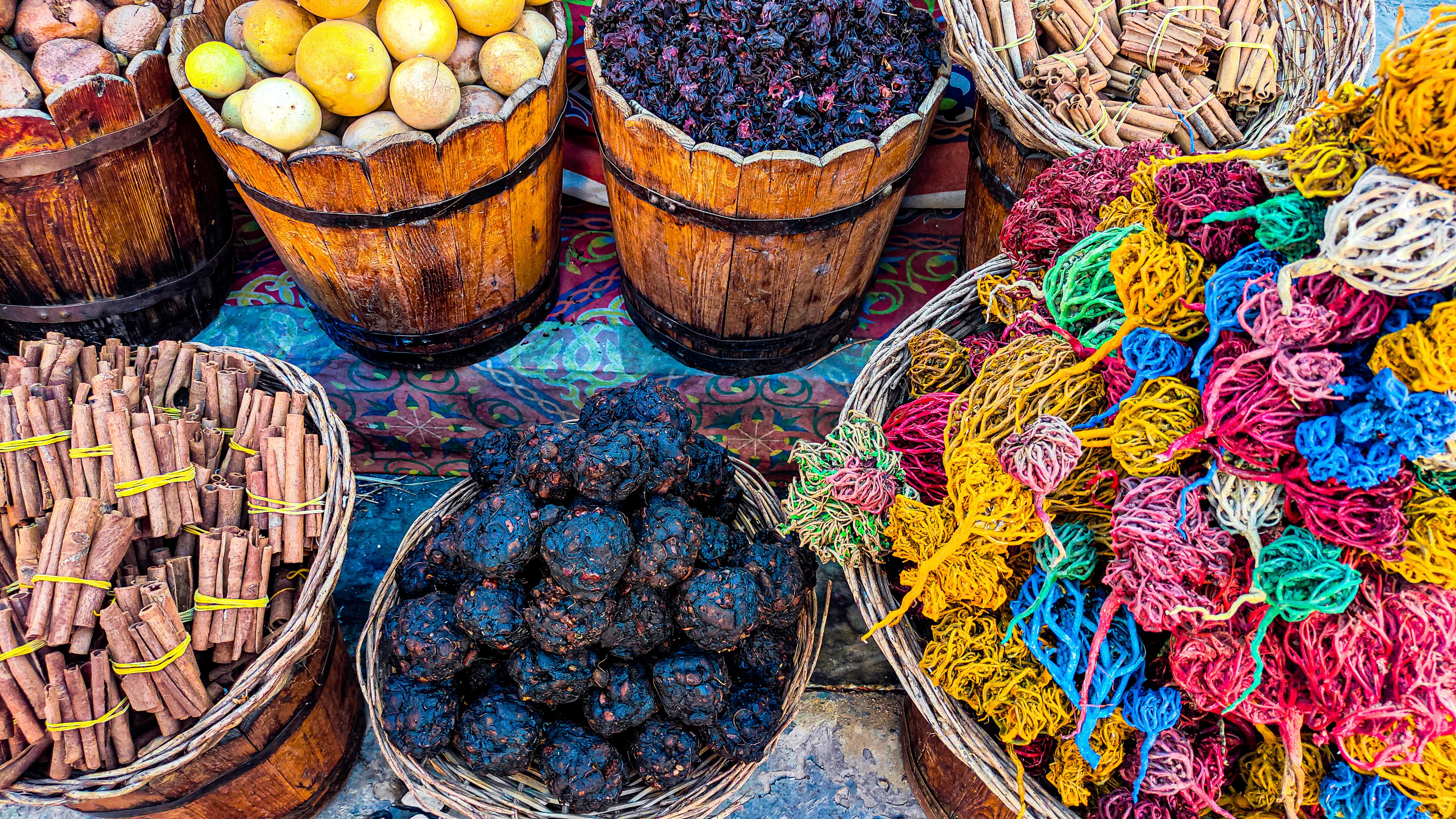 Colorful spices and herbs in baskets at a traditional market. Warm, inviting, and vibrant.