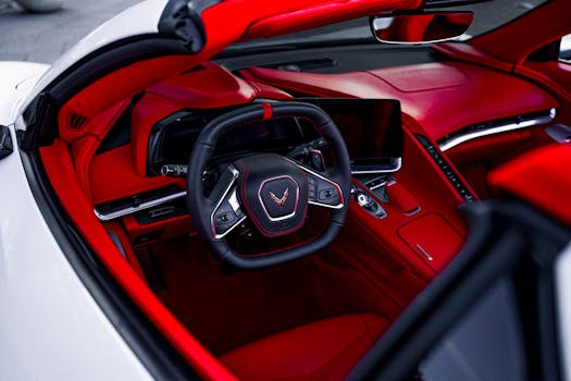 Close-up view of a luxury sports car with bold red interior, showcasing modern design and high-end features.