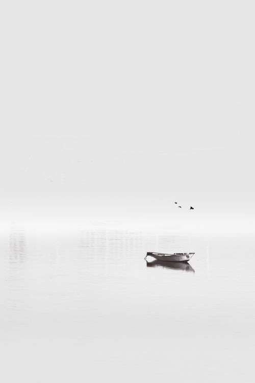 Free Serene black and white image of a lone boat on the Nile River, capturing tranquility. Stock Photo