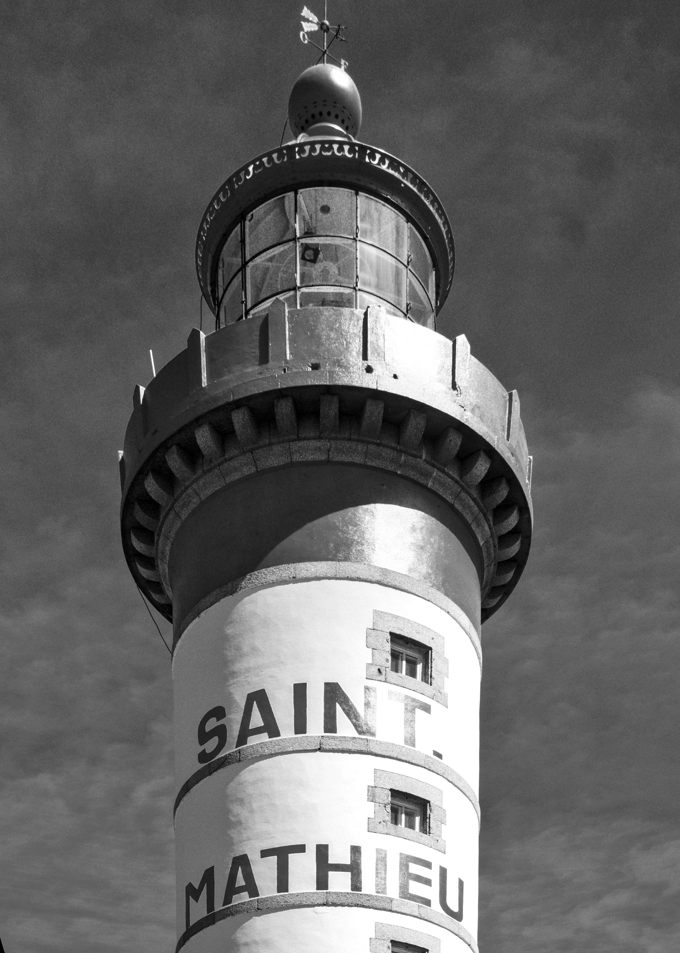 Black and white photo of Saint Mathieu Lighthouse in Brittany, capturing architectural details.