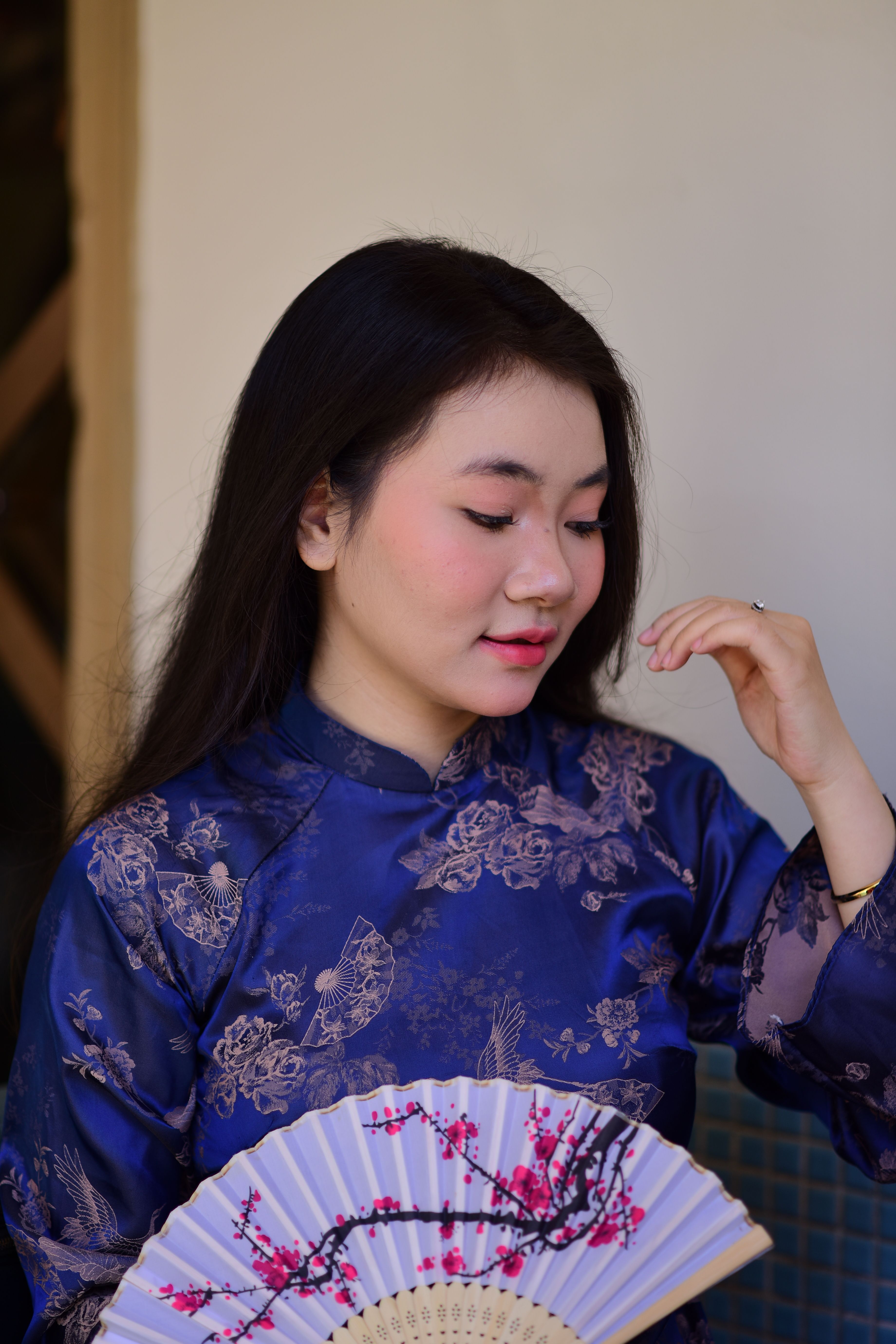 Woman in Traditional Blue Ao Dai with Hand Fan · Free Stock Photo