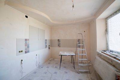 Kitchen under renovation with ladder and bare walls — photo by Valentin Ivantsov on Pexels
