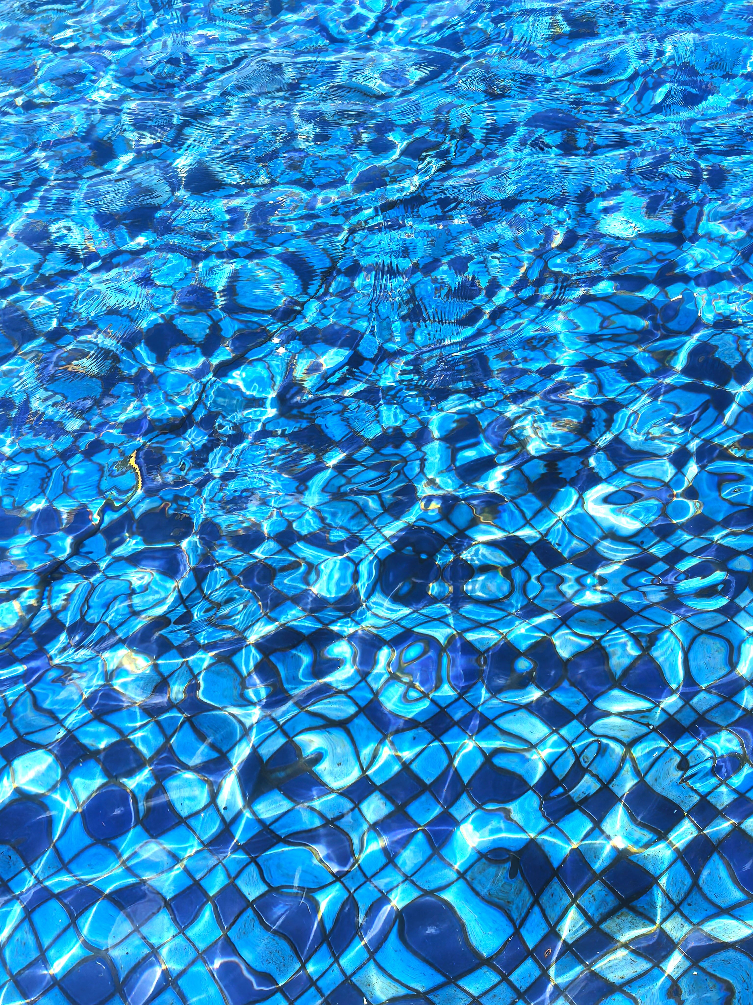 Vibrant Blue Pool Water with Sunlit Patterns · Free Stock Photo