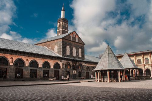 Free The historic Grand Mosque of Diyarbakır with its unique architecture under a wide, clear sky. Stock Photo