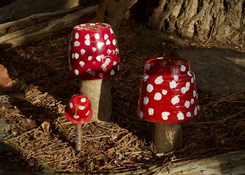 Colorful ceramic mushroom art pieces in an outdoor forest scene.