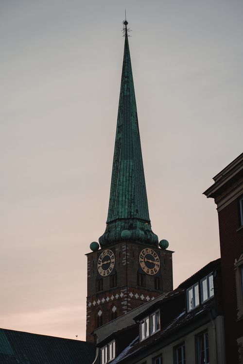Free A striking view of St. Peter's Church tower against a twilight sky in Munich, Germany. Stock Photo
