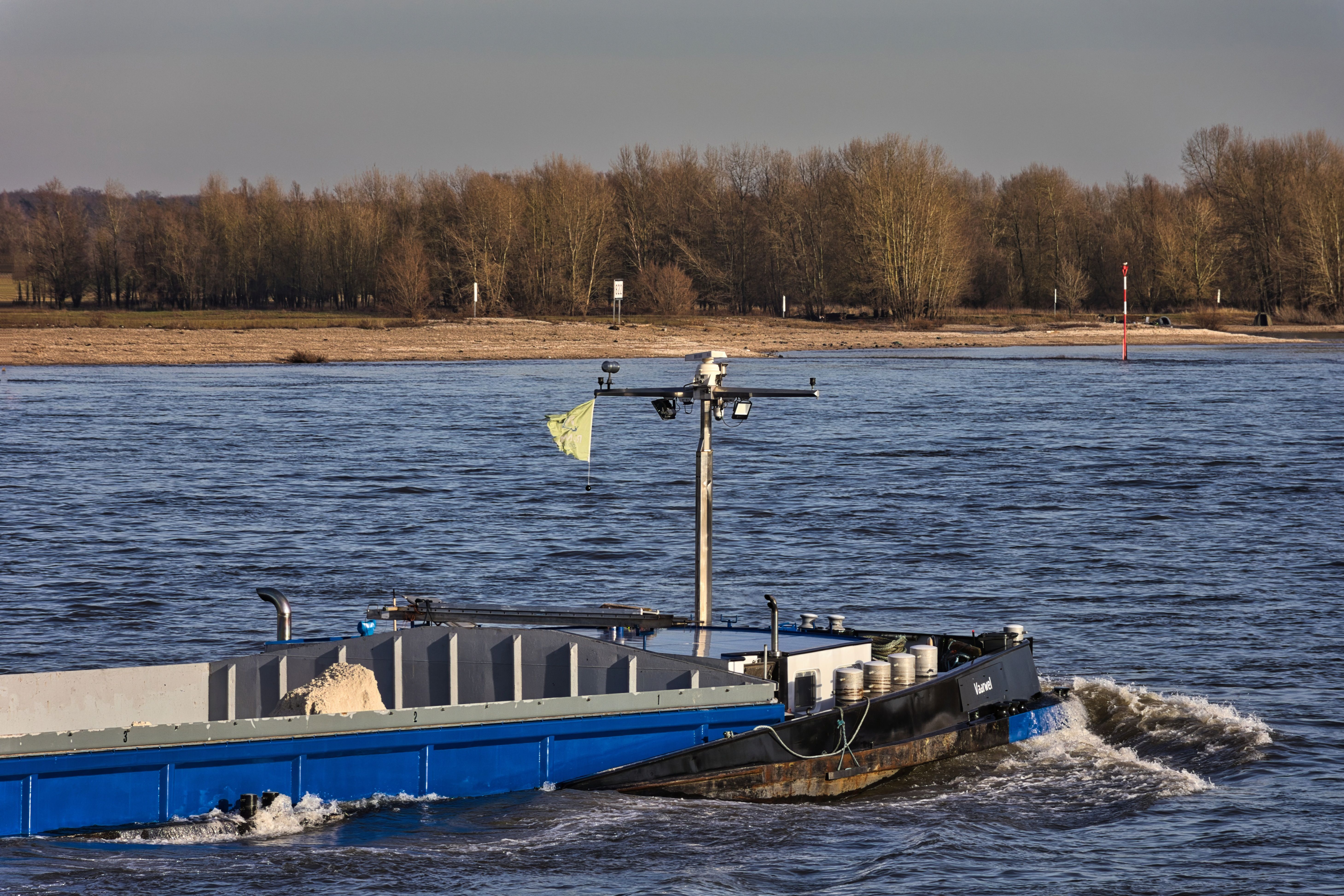 Bateau naviguant au crépuscule, feux de navigation allumés