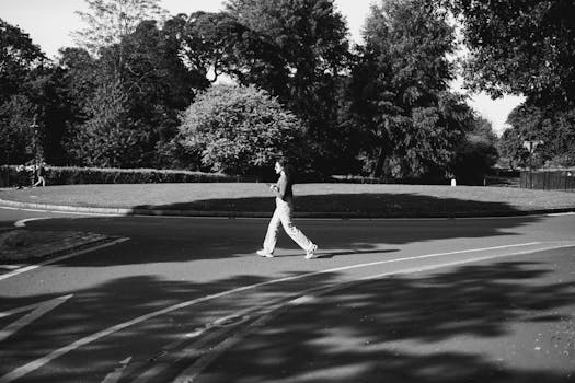 Monochrome image of a woman walking through an urban park in Dublin.